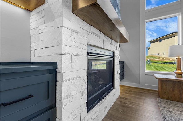 17186 S Heatherwood St, Olathe, KS 66062 - detailed view of a fireplace, wood finished floors, and baseboards