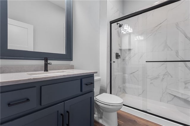 17186 S Heatherwood St, Olathe, KS 66062 - bathroom with toilet, vanity, a marble finish shower, and wood finished floors