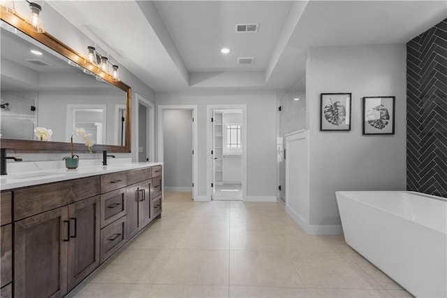 17186 S Heatherwood St, Olathe, KS 66062 - bathroom with a shower stall, double vanity, a freestanding bath, tile patterned flooring, and recessed lighting