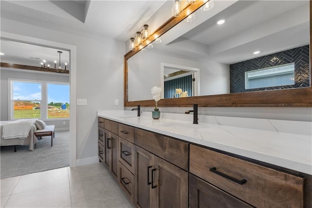 17186 S Heatherwood St, Olathe, KS 66062 - ensuite bathroom with double vanity, tile patterned floors, baseboards, and recessed lighting