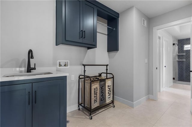 17186 S Heatherwood St, Olathe, KS 66062 - laundry area featuring hookup for a washing machine, cabinet space, baseboards, and light tile patterned floors