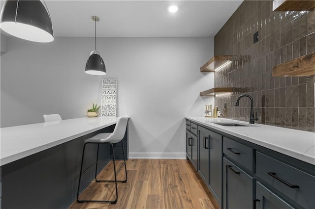 17186 S Heatherwood St, Olathe, KS 66062 - kitchen with open shelves, a sink, light wood finished floors, decorative light fixtures, and decorative backsplash