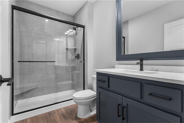 17186 S Heatherwood St, Olathe, KS 66062 - full bath with toilet, vanity, a stall shower, and wood finished floors