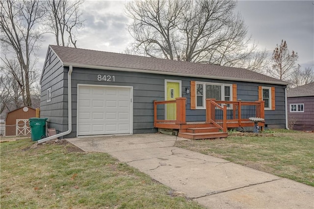 single story home featuring a front lawn and a garage