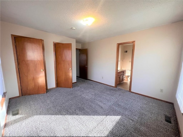 unfurnished bedroom with visible vents, light colored carpet, a textured ceiling, and baseboards