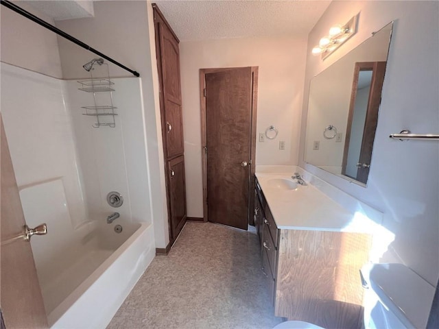 full bath with a textured ceiling,  shower combination, and vanity