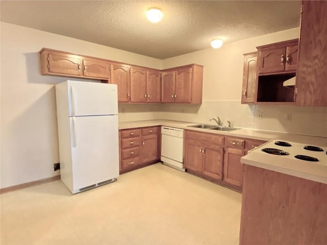 kitchen with light floors, exhaust hood, white appliances, a textured ceiling, and a sink