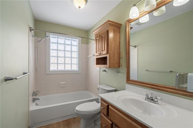 full bathroom with vanity, toilet, tiled shower / bath combo, and wood-type flooring