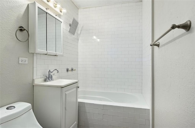 full bathroom with toilet, tiled shower / bath combo, and vanity