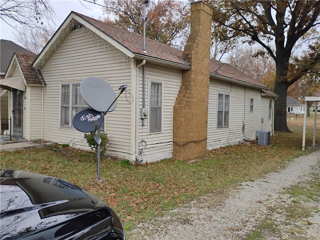 view of side of home featuring central AC