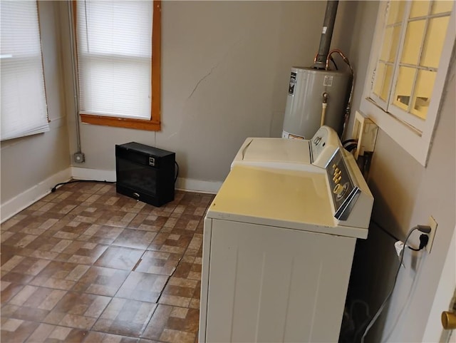 washroom featuring water heater and washing machine and dryer