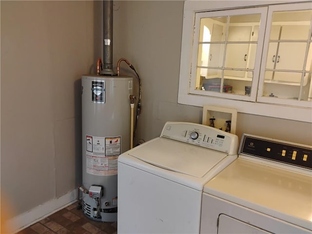 washroom with washing machine and dryer and gas water heater