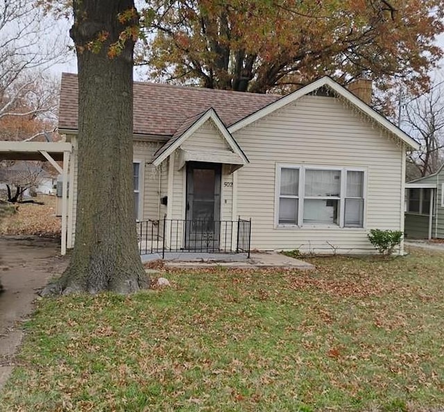 bungalow-style house featuring a front yard