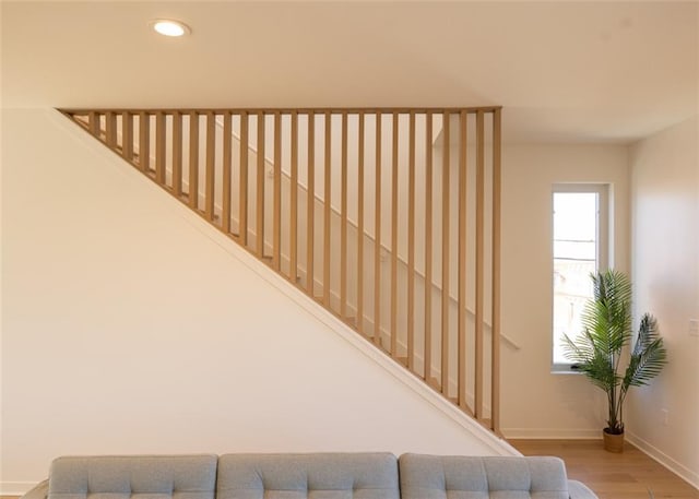 stairs featuring recessed lighting, wood finished floors, and baseboards