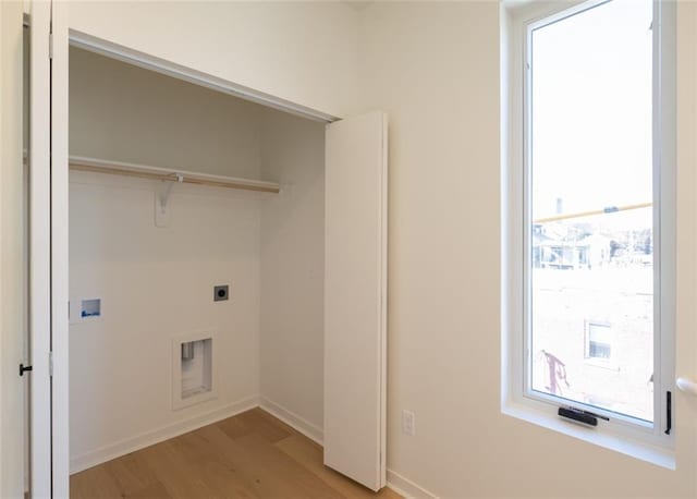 laundry area with baseboards, hookup for an electric dryer, laundry area, light wood-style flooring, and washer hookup