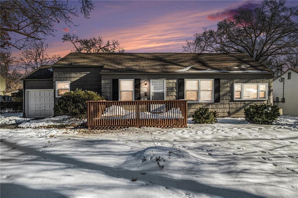 view of front of property featuring a garage and a wooden deck