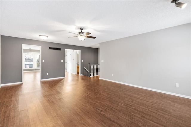 unfurnished room featuring hardwood / wood-style flooring, a textured ceiling, and ceiling fan