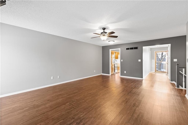 unfurnished living room featuring hardwood / wood-style flooring, a textured ceiling, and ceiling fan