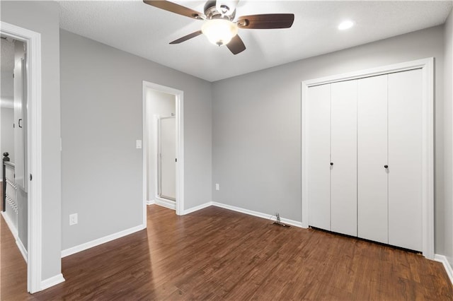 unfurnished bedroom featuring a closet, ceiling fan, and dark hardwood / wood-style flooring