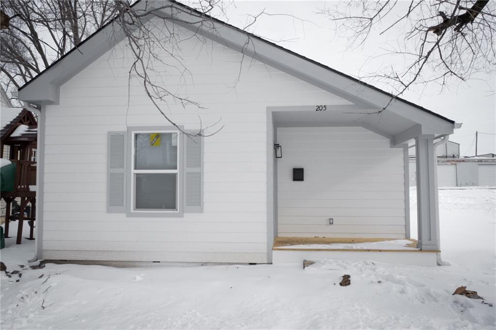 view of snow covered rear of property