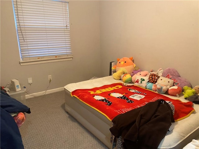 bedroom featuring baseboards and carpet