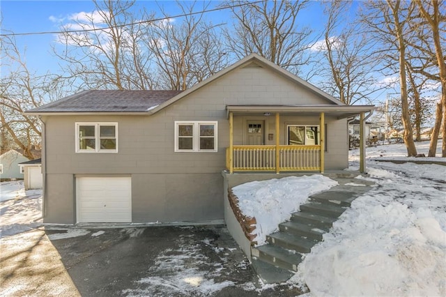 view of front of home with a garage and a porch