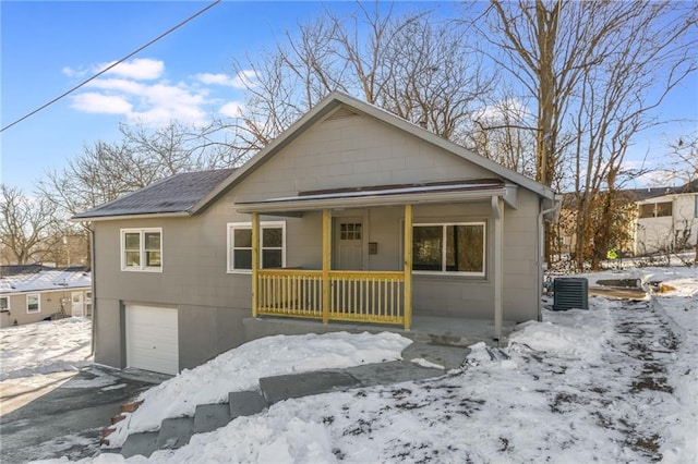 bungalow-style home featuring a garage and a porch