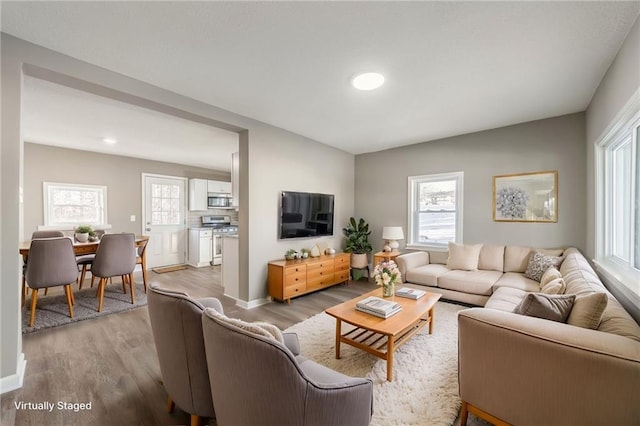 living room with plenty of natural light and light wood-type flooring