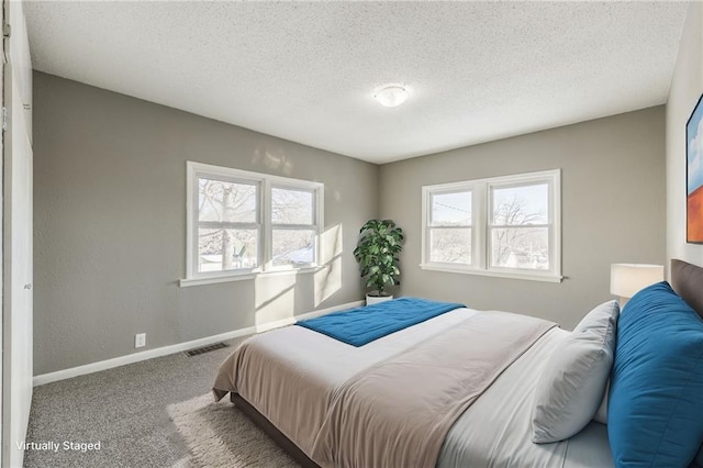 carpeted bedroom featuring a textured ceiling