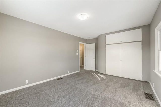 unfurnished bedroom with light carpet and a closet