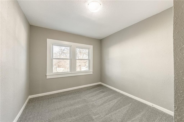 spare room with carpet floors and a textured ceiling