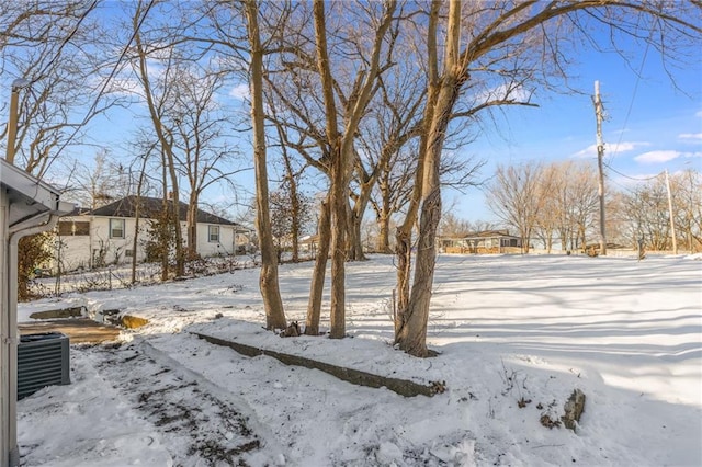 snowy yard featuring cooling unit