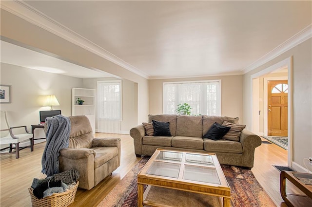 living room with ornamental molding and light hardwood / wood-style flooring