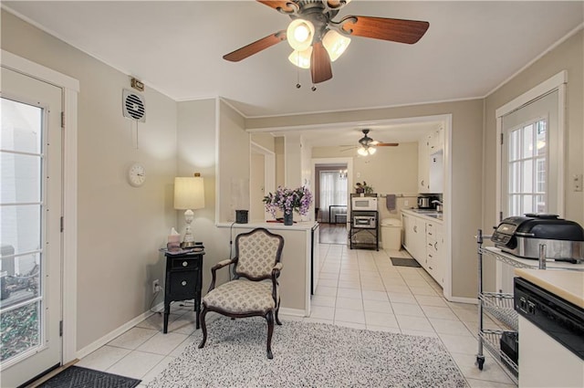 living area with light tile patterned flooring, a healthy amount of sunlight, and crown molding