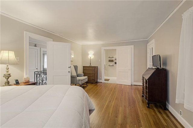 bedroom with crown molding and hardwood / wood-style flooring