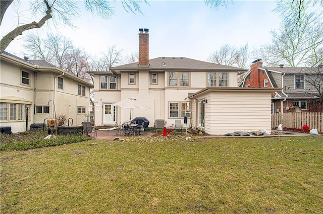 back of house featuring cooling unit, a patio, and a lawn