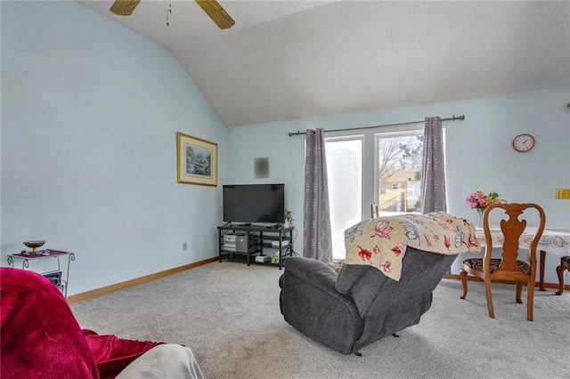 carpeted living room featuring ceiling fan and lofted ceiling