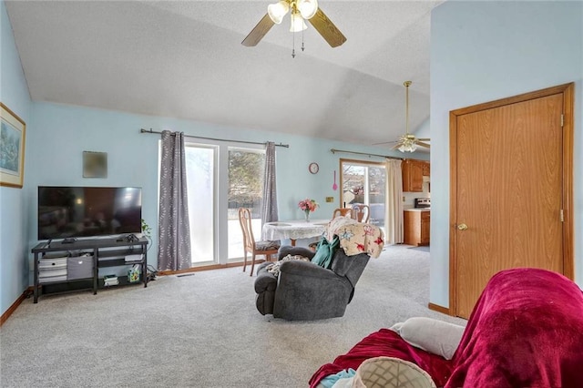 carpeted living room featuring ceiling fan and lofted ceiling