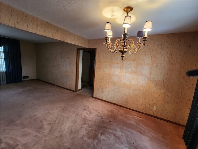 unfurnished dining area with an inviting chandelier and carpet