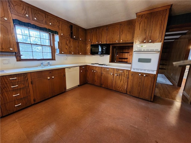 kitchen with white appliances and sink