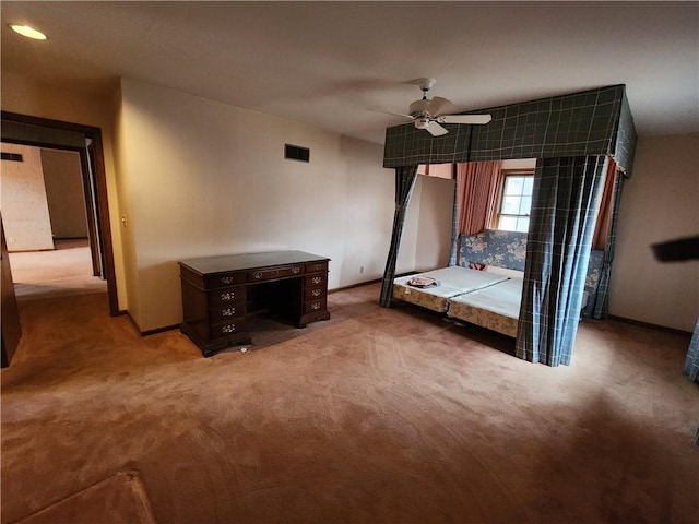 unfurnished bedroom with light colored carpet and ceiling fan