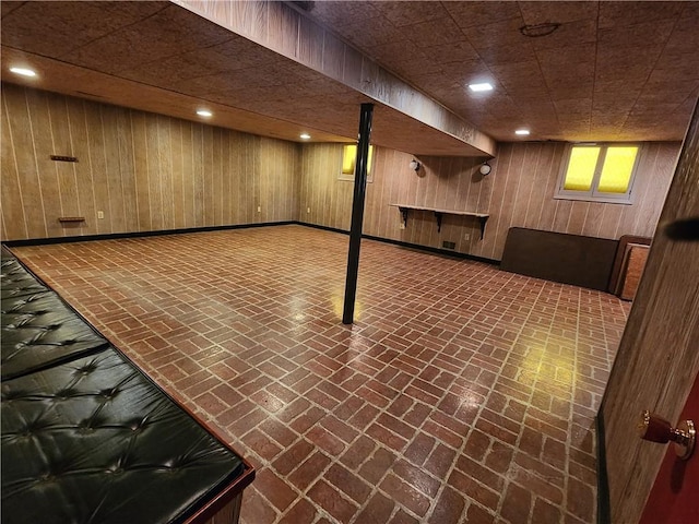 basement featuring wood walls