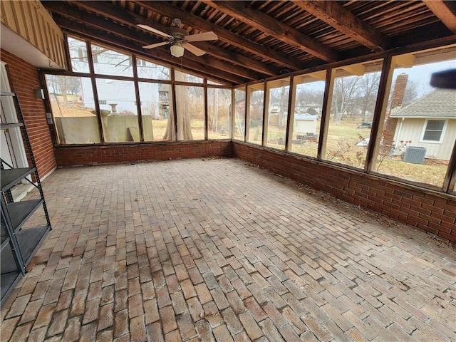 unfurnished sunroom featuring vaulted ceiling with beams and ceiling fan