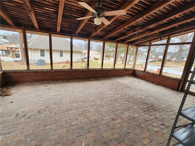 unfurnished sunroom with ceiling fan