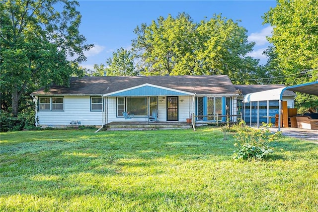 view of front of house with a front lawn and a carport