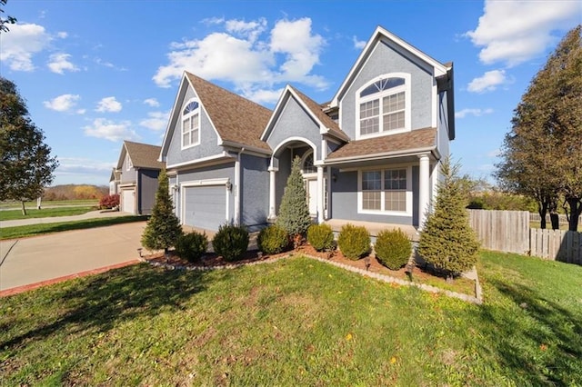 view of front of property featuring a garage and a front lawn