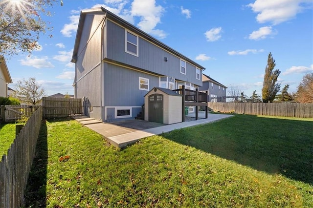 back of house with a storage unit, a lawn, and a patio