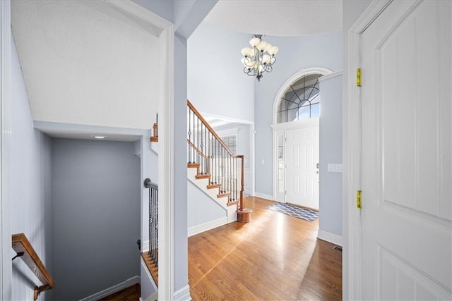 entryway with a chandelier and hardwood / wood-style flooring