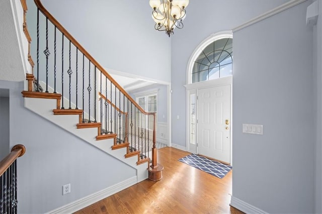 entrance foyer with an inviting chandelier and hardwood / wood-style flooring