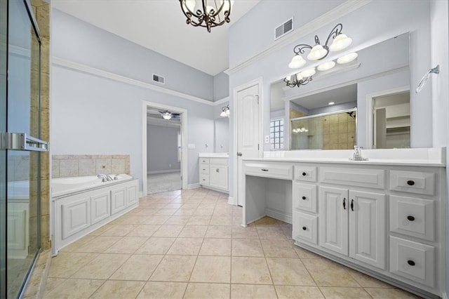 bathroom featuring vanity, tile patterned flooring, a towering ceiling, independent shower and bath, and ceiling fan with notable chandelier